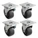 A set of 4 Beverage-Air black rubber plate casters with steel plates.