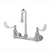 A T&S chrome wall mount faucet with two gooseneck spouts and wrist action handles.
