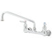 A T&S chrome wall mount faucet with two handles and a swing nozzle.