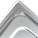A Vollrath stainless steel solid cover on a metal tray.