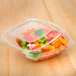 A Sabert clear plastic container with a colorful vegetable salad inside.