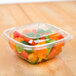 A Sabert clear plastic container filled with cut up carrots, peppers, and other vegetables.