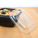 A clear Sabert plastic container lid on a bowl of food.