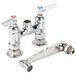 A T&S chrome deck-mount mixing faucet with two faucets and two handles.
