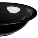 A close-up of a black Carlisle Sierrus melamine bowl with a black rim.