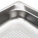 A Vollrath stainless steel hotel pan with holes in it.