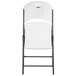 A white Lifetime folding chair with a black frame.