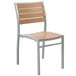 A BFM Seating Largo outdoor restaurant chair with a synthetic teak wood back and metal frame.