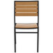 A BFM Seating Largo outdoor side chair with a black frame and synthetic teak wood back.