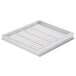 A stainless steel Bakers Pride metal grate with holes.