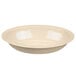 A tan oval rimmed bowl on a white background.