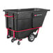 A black Rubbermaid tilt truck for trash with wheels.