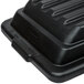 A black Rubbermaid lid with a hinged dome for tilt trucks.