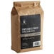 A brown bag of Crown Beverages Emperor's Finest Whole Bean Coffee.