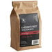 A brown bag of Crown Beverages Emperor's Finest Whole Bean Decaf Coffee.