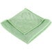 A Unger green medium-duty microfiber cleaning cloth folded on a white background.