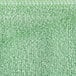 A close up of a green Unger SmartColor Microfiber Cleaning Cloth with a white border.