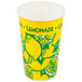 A yellow and green paper cup with lemons on it filled with lemonade.