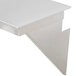 A Bakers Pride stainless steel splashguard with a triangular edge on a white table.