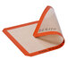 A close-up of a SILPAT® half-size silicone baking mat with an orange and white label.