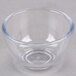 A clear plastic Carlisle souffle cup on a white surface.