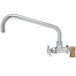 A T&S polished chrome wall mount faucet with a 12" swing nozzle and 4 arm handle.