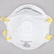 A white Cordova N-95 face mask with yellow straps.