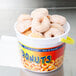A plastic bucket filled with mini donuts.