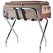 A CSL metal folding luggage rack with a suitcase on it.