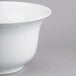 A close-up of a Tablecraft white cast aluminum tulip bowl.