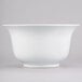 A white Tablecraft cast aluminum tulip salad bowl with a white rim on a white surface.