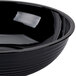 A black Cambro Camwear round ribbed bowl.