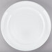 A white Tuxton Concentrix china plate with a spiral design.