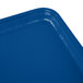 A close up of a blue Cambro rectangular tray on a table.