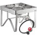 A stainless steel Backyard Pro outdoor gas stove with a hose attached.
