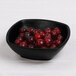 An Elite Global Solutions black melamine square bowl filled with red berries.