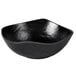 An Elite Global Solutions black melamine bowl with a curved edge.