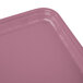 A close up of a rectangular pink Cambro fiberglass tray.