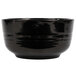 A black Tablecraft bowl with speckled texture and green specks.