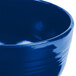 A close up of a Tablecraft cobalt blue cast aluminum fruit bowl.