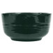 A black Tablecraft cast aluminum fruit bowl with a speckled surface and a green rim.