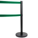 A black pole with dual green retractable belts.