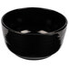 A black Tablecraft cast aluminum fruit bowl with a curved edge.