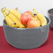A Tablecraft granite cast aluminum fruit bowl filled with apples and bananas.