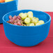 A Tablecraft sky blue cast aluminum fruit bowl filled with grapes.