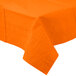 A Sunkissed Orange Creative Converting tablecloth on a table.