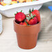A Tablecraft copper condiment bowl filled with strawberries on a table.