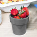 A Tablecraft granite condiment bowl filled with strawberries on a table.