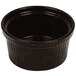 A black cast aluminum souffle bowl with ridges.