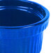 A close up of a blue Tablecraft cast aluminum souffle bowl with ridges.